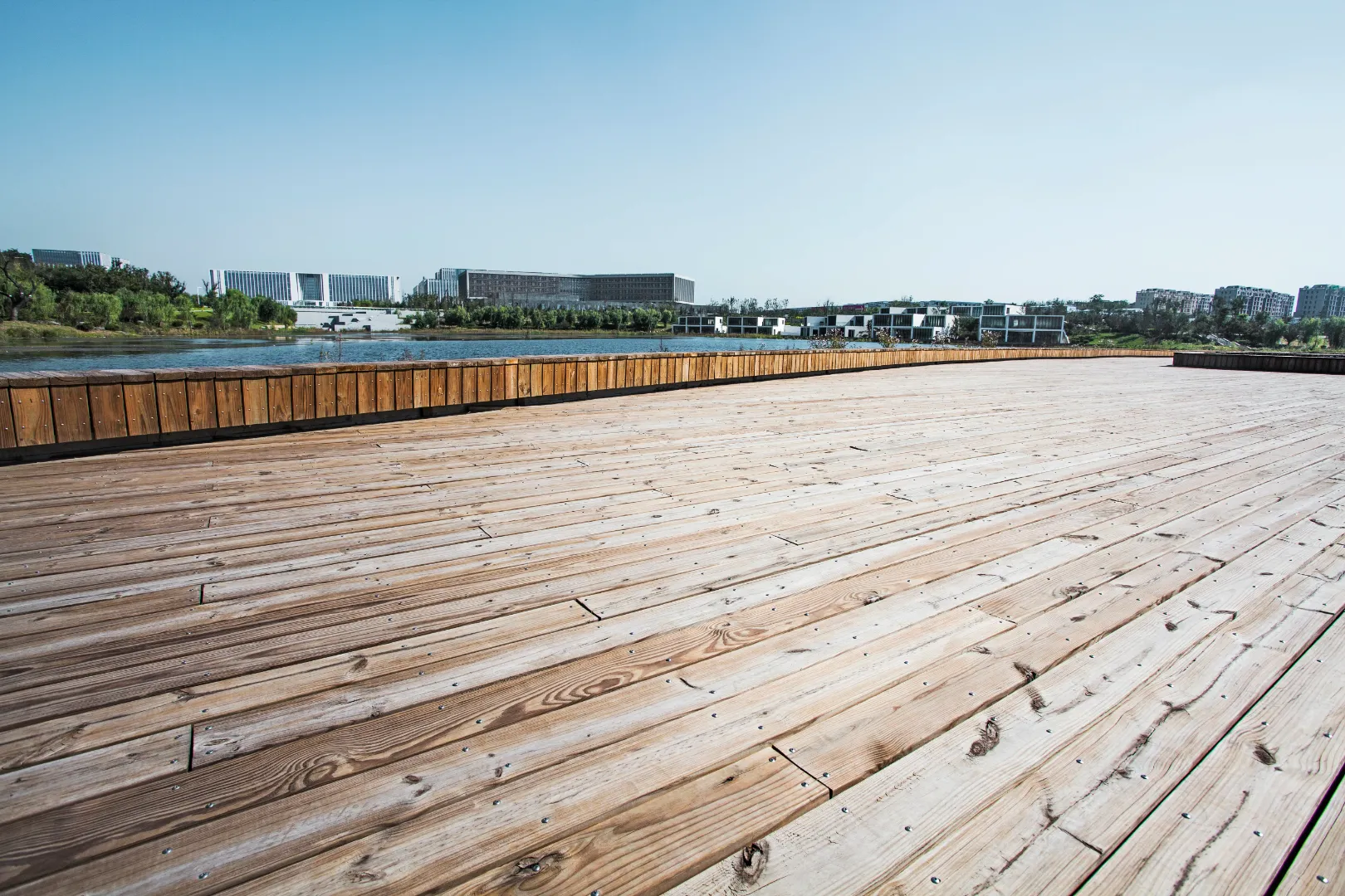 Natural hardwood decking boards covering a waterfront outdoor deck